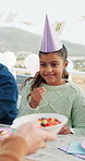 Smile, child and candy at party outdoor for birthday, celebration and social gathering. Happy, kid and eating sweets with dessert, family event and bonding together for milestone at special occasion