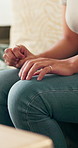 Anxiety, hands and woman on sofa in house with nervous, mental health or stress in living room. Frustration, overthinking and female person with worry for decision, choice or trauma in apartment.