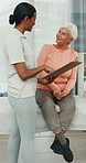 Physio, clipboard and senior woman in clinic with discussion, update or good news for rehabilitation. Elderly person, healthcare worker and talk with checklist, physical therapy or healing for injury