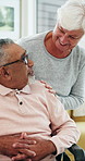 Happy, bonding and old couple relax in home for love, marriage and connection together. Smile, care and senior man with woman in retirement on sofa for commitment and hug in living room of house