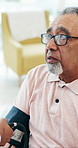Old man, blood pressure test and talk at clinic with nurse, equipment or wellness check in retirement. Elderly patient, medical professional and monitor with assessment, discussion or healthcare exam