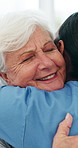 Hug, nurse and senior woman in home, smile and support for recovery, healing and healthcare. Apartment, medical service and old person in lounge, caregiver and embrace for empathy, help and gratitude