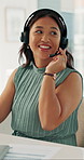 Woman, headset and smile at call center with typing for report, feedback and advice at insurance company. Person, consultant or advisor with voip mic, happy and help desk at risk management agency