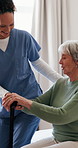Nurse, old woman and walking stick on bed with help for balance, steps and smile with service in home. People, caregiver and patient with disability, cane or support for rehabilitation in retirement