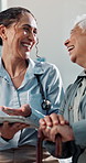 Doctor, laugh and senior woman with tablet for medical consultation, recovery and humor in hospital. Happy, healthcare worker and elderly person with disability, tech or funny discussion for healing.