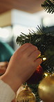 Hands, kid and ball with bauble for Christmas decoration, celebration and holiday tradition. Closeup, person or child with ornament for festive season, xmas event and family bonding for party in home