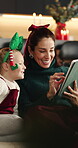 Couch, mother and girl with tablet for Christmas movie,  subscription app and discussion for video choice. Home, child or happy woman with tech for streaming, scroll or talk for festive film decision