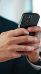 Hands, phone and texting at office with contact, check notification and coworking at finance agency. Person, broker or financial advisor on app, typing and scroll with career at investment company