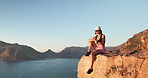 Hiking, break and woman with phone on mountain, vacation adventure and social media for nature post. Mobile, trekking holiday and person with message app for communication, space and texting on cliff
