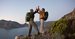 Friends, hiking and high five on mountain with hug, sea view or achievement for backpacking trip. Women, embrace and celebration on cliff with ocean scenery, bonding or success for trekking adventure