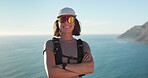 Happy, hiking and face of woman outdoor by ocean for discovery, adventure or exercise on holiday. Smile, sunglasses and portrait of female person in nature for trekking by sea for active on vacation.
