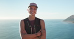 Smile, hiking and face of woman in nature by ocean for discovery, adventure or exercise on holiday. Happy, fitness and portrait of female person outdoor for trekking by sea for active on vacation.