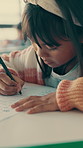 Writing, education and child in classroom at school with learning for test, assignment or quiz. Scholarship, growth and girl student with activity for development, studying or knowledge in lesson.