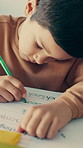 Writing, education and kid in classroom at school with learning for test, assignment or quiz. Scholarship, growth and boy student with activity for development, studying or knowledge in lesson.