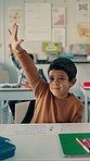 Question, learning and child in classroom at school for education, knowledge or studying. Help, raised arm and boy student with answer for development, growth or quiz with scholarship at academy.