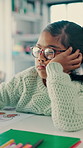 Girl, thinking and bored in classroom at school with glasses, distracted and tired with education. Kid with learning disability, wonder and paper with scholarship, books and development at academy