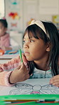 School, thinking and girl in classroom for drawing, education and creative lesson for child development. Academy, youth and kid with stationery for learning, studying and ideas with picture at desk