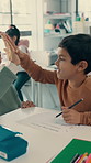 School, high five and child with teacher in classroom for writing, education and lesson for success. Academy, youth and kid celebrate for learning, studying and good answer with educator at desk