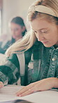 Education, writing and paper with student in classroom for problem solving, assessment and learning. Studying, teenager and knowledge with people in high school for academy, scholarship and course
