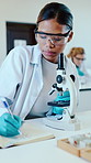University, chemistry and woman with microscope for notes, science and research project. Students, microbiology and education with notebook, classroom and laboratory with scholarship and knowledge