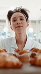Woman, chef and tray with muffins at bakery with walk, cooking and preparation at confectionery store. Person, pastry and baker with cake for order, process and cuisine with dessert at restaurant