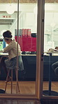 Cafe, customer or people by window with reflection, eating or hospitality service with tech at night. Coffee shop client, man and woman relax with food, drink and tablet by storefront in city