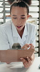 Woman, clipboard and laptop at bakery for admin, sales or inventory management with review at restaurant. Person, small business owner and chef with documents, checklist and typing for stock at diner