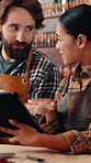Leather workshop, people and tablet with conversation, planning and tools for unique textile product. Ecommerce, online sales and man with woman in small business for tannery, schedule or discussion