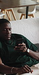 Relax, friends and men in home, smartphone for social media and digital app for communication. Apartment, mobile use and people on couch, comfort and cellphone for online chatting and connection
