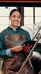 Face, woman and tablet in factory with smile, leather apron and online research for textile production. Happy, person and artisan in workshop with tech, experience and shelf for fabric manufacturing.