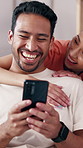 Couple, laughing and hug with phone at house for love, social media and reading meme in lounge. Smile, people and embrace with mobile for streaming, funny video and partner affection in living room
