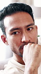 Thinking, upset and man on sofa in home with reflection for mistake, bad memory and breakup. Apartment, thoughtful and person on couch with regret, wondering and angry for relationship failure