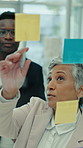 Manager, people and brainstorming at glass wall with sticky note, planning or mentorship for marketing. Management, team and discussion in office with advertising strategy, training or collaboration.
