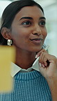 Glass wall, planning and business woman in office for financial strategy, agenda or insight. Sticky note, think or happy consultant brainstorming for investment, project management or problem solving
