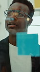 Creative, brainstorming and black man at glass wall with sticky note, thinking and idea for marketing. Person, vision and problem solving in office with strategy, planning and advertising project.