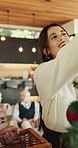 Christmas, tree and woman in home, decoration for festive season and holiday in living room. Apartment, vacation and person with happiness, aesthetic or ornament for celebration, Xmas event or bauble