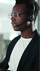 Talking, headset or black man in office for customer care, online consultation or troubleshooting advice. Speaking, contact or call center agent with solution for tech support, hotline or assistance