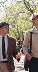 Business, commute and taking with men in park together for discussion, feedback or planning. Conversation, teamwork and walking with employee people outdoor for morning travel or trip to work