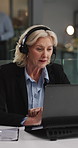 Mature, woman and night with headset of agent in office for online legal advice, support or help. Female person, consultant attorney or lawyer working late with mic on laptop for virtual assistance