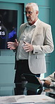 Business, presentation and man in meeting, planning for investment deal and feedback for profit. Mature person, financial advisor and employee in workplace, conversation and speaker for economy info