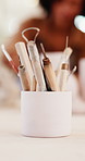 Pottery, workshop and cup with tools, art and sculpture design for production in small business. Ceramic, mug and equipment on table with people in creative studio for handcraft, hobby or class