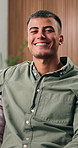 Face, relax and man with smile in living room for staycation, day off and weekend break for wellness. Chill, positive attitude and person with laugh to unwind in home, portrait and free time for rest
