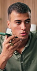 Phone call, talking and man in lounge, loudspeaker and digital app for communication. Conversation mobile user and person in home, cellphone and chatting with recording, sound or question for contact