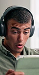 Headphones, tablet and man shocked on home sofa for streaming, podcast or internet to relax. Male person, technology and wow subscription in house for surprise offer, online news or amazing deal