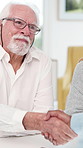 Smile, financial advisor and handshake with old couple in home for meeting, budget or report. Shaking hands, investment growth and retirement savings with people in house for deal and thank you
