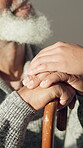 Old man, people and holding hands in nursing home with walking stick, empathy and support in connection. Understanding, kindness and person with disability, comfort and sympathy in retirement care.