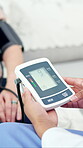 Doctor, patient and hands in hospital with blood pressure machine, wellness and healthcare checkup. Nurse, people and tech in clinic with medical equipment for hypertension, test results or diagnosis