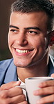 Thinking, coffee and man in home, smile and reflection for memory, happiness and relax. Apartment, herbal tea and man in lounge, nostalgia and weekend break with morning routine, peace and comfort