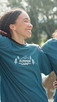 Volunteer, group or laugh with hug at summer camp for bonding, community service or solidarity. Workers, people or happy team on campsite for holiday program support, healthy relationship or embrace