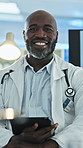 Face, medical and tablet with black man doctor in hospital for development, planning or research. App, healthcare and smile with mature African surgeon in clinic for insurance, records and wellness
